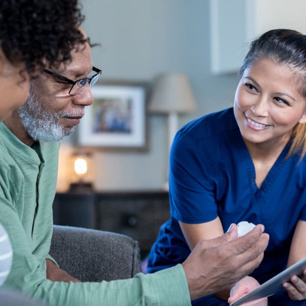 female caregiver going over medication with clients