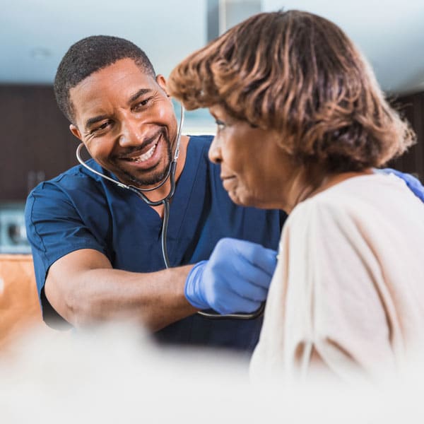 male caregiver checking patient's vitals